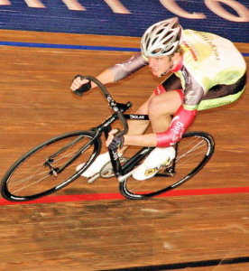 world class male cyclist head down flat out on the track