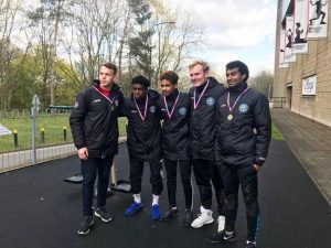 five young footballers wearing their medals having won a school tournament